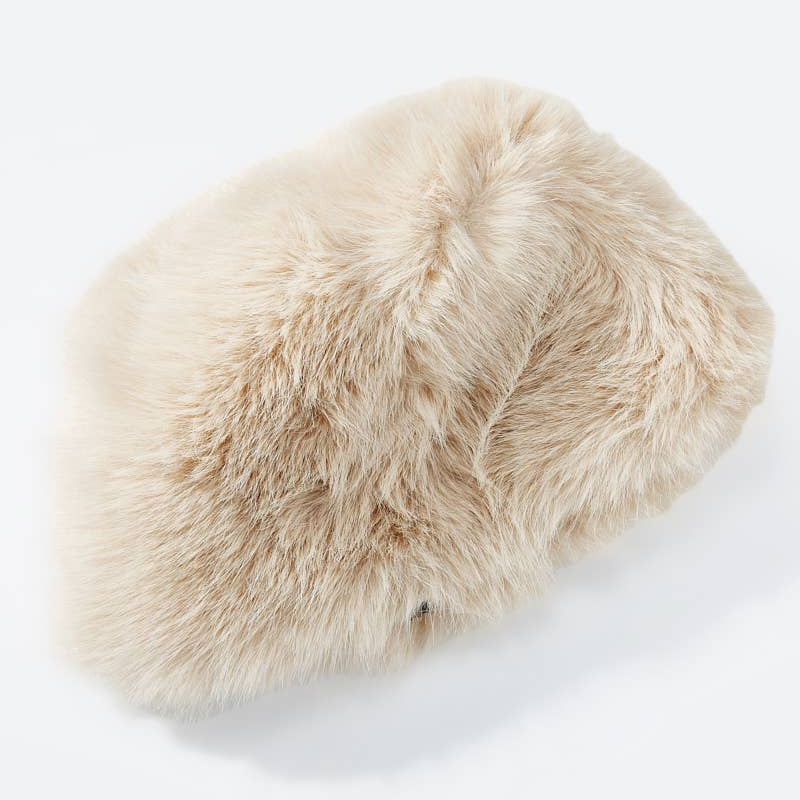 Beige fluffy hat on a white background