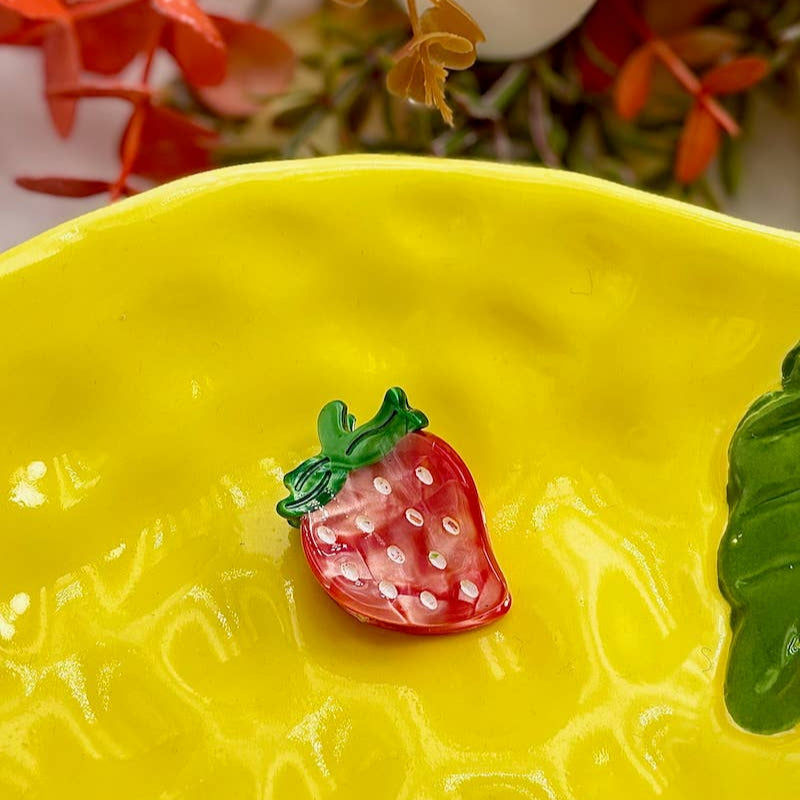 Yellow ceramic dish with a strawberry decoration on a floral background
