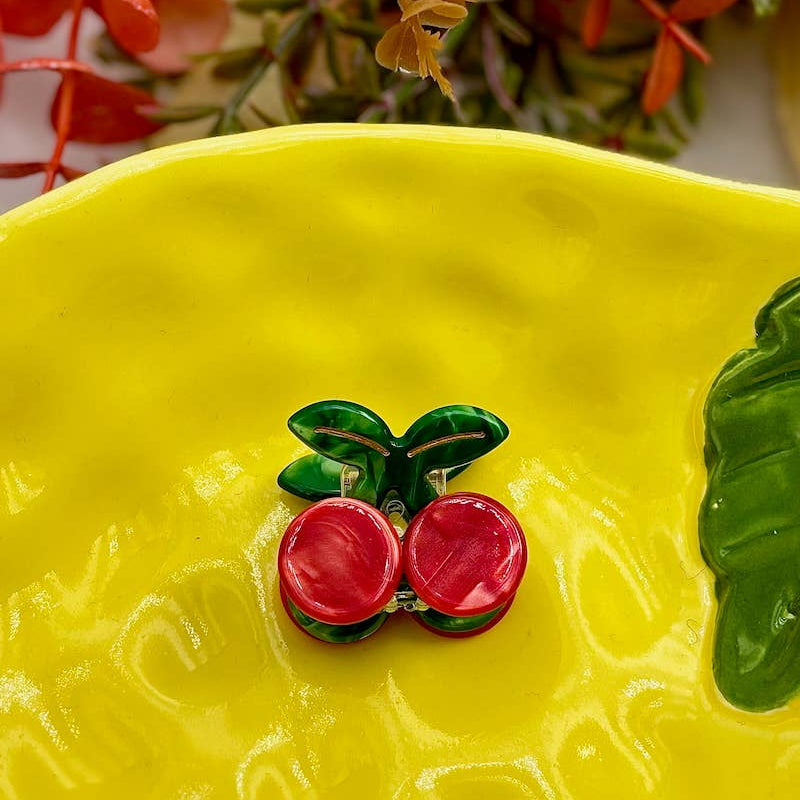 Yellow ceramic plate with cherry design on a floral background