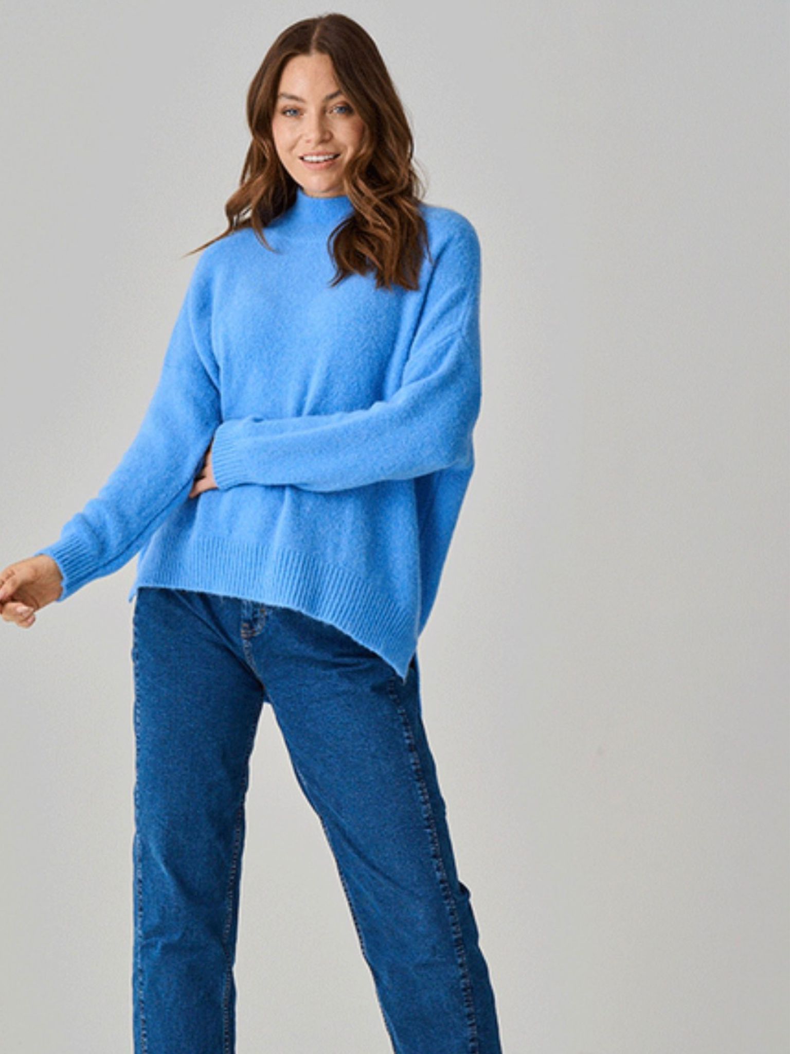 Lulu Alpaca Knit Funnel Neck Jumper Sky Blue, paired with blue jeans and neutral background