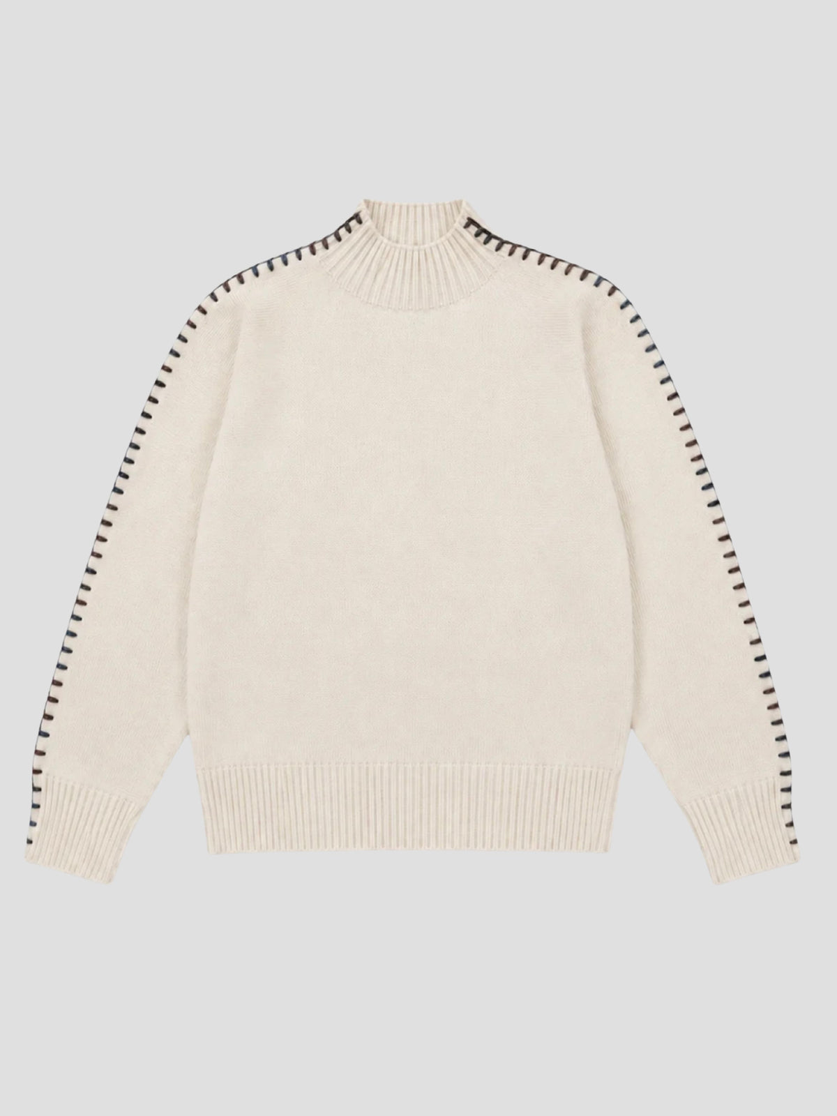 An off-white knit sweater with black dotted stitch detailing running down the sleeves, displayed flat against a light gray background.