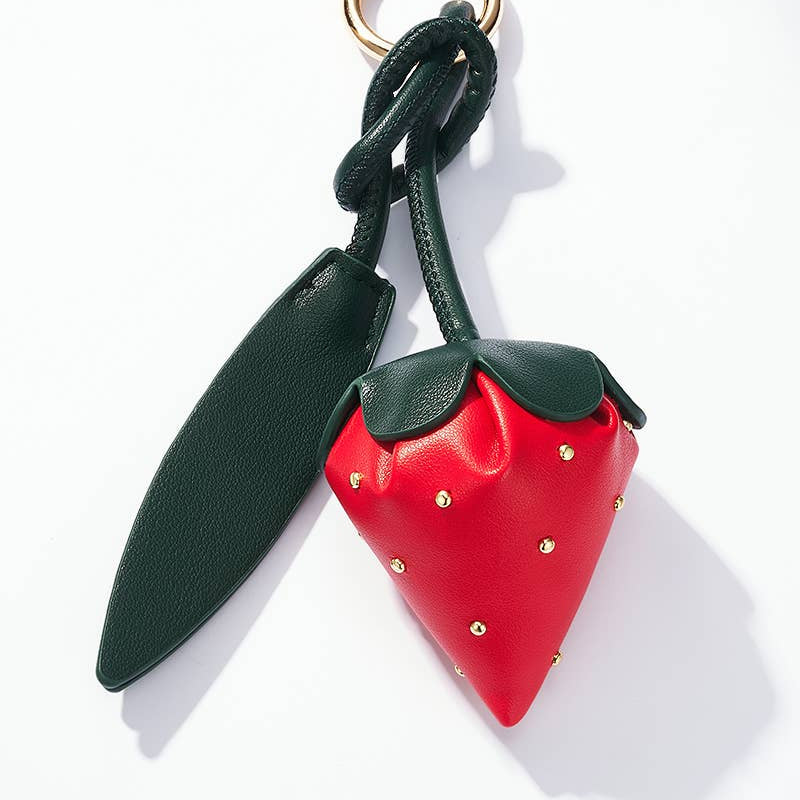 Strawberry-shaped keychain with green top and red body on a white background